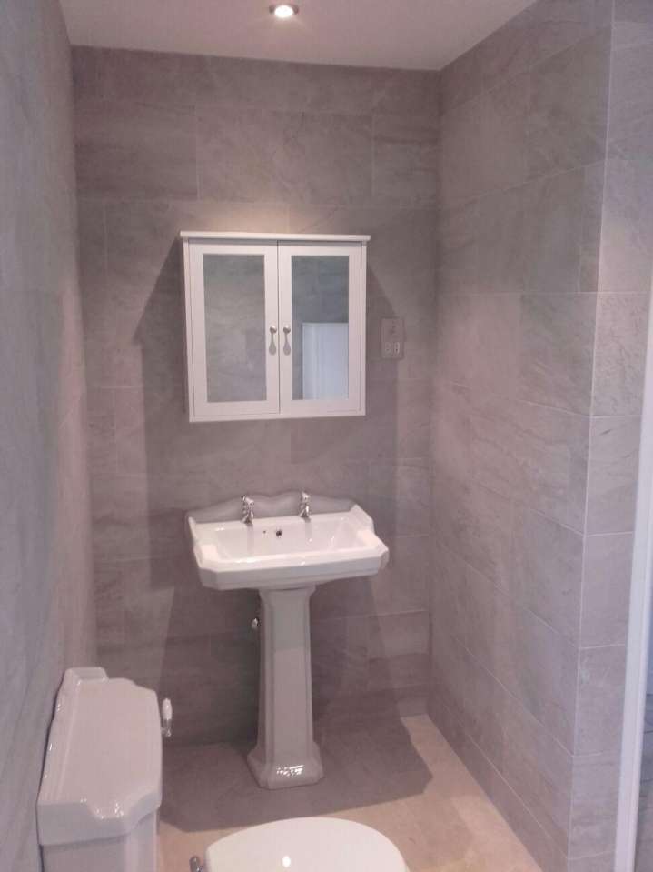 bathroom with floor and wall tiling